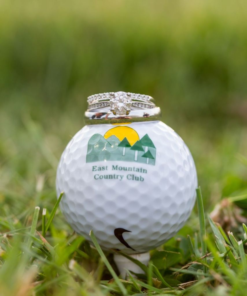 Rings sitting on top of the East Mountain Country Club golf ball teed up 